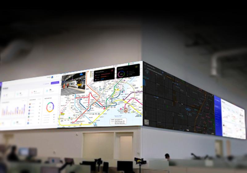 Video wall in a noc control room displaying transit maps and data dashboards
