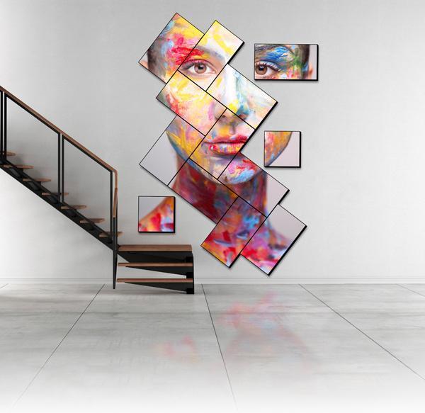 一个现代的楼梯和一个艺术性的马赛克视频墙，展示了一个画脸的艺术作品