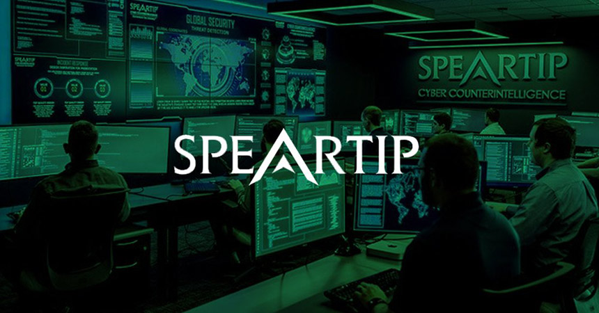 Speartip网络反间谍安全操作中心，有显示数据的视频墙，工作站的工人有绿色覆盖和标志。